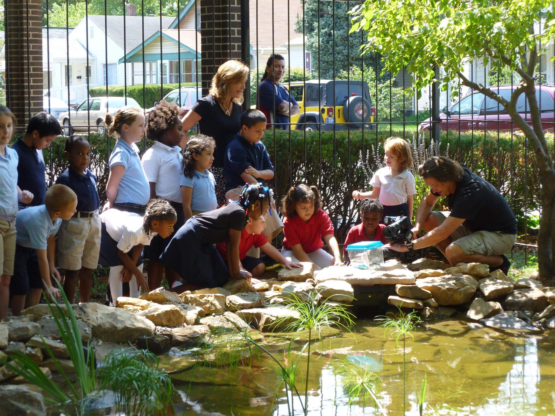 Kids gather round upon learning about water