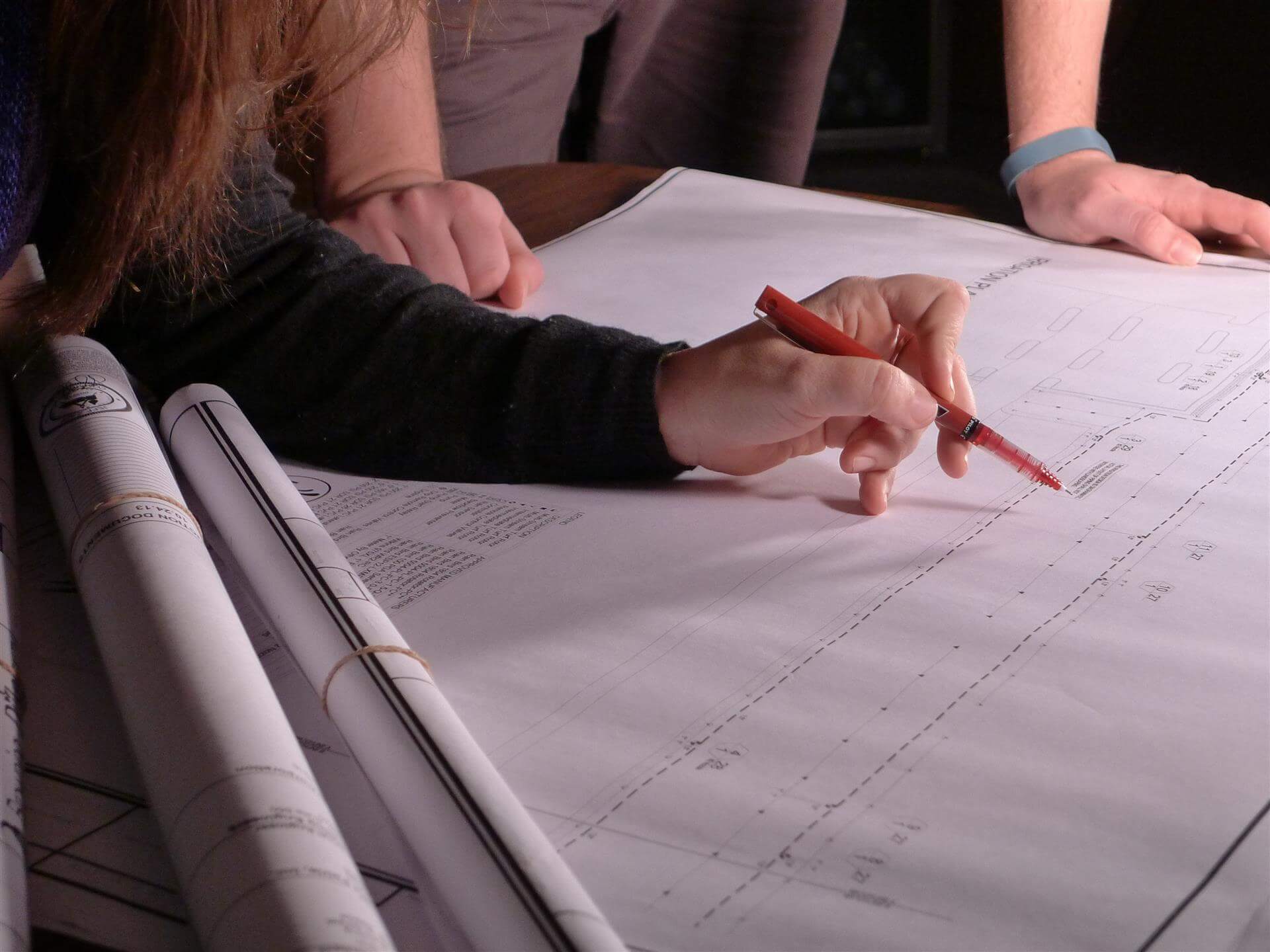 People gathered around a architectural diagram